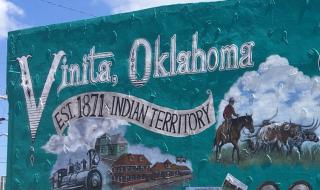 public art mural of Vinita Oklahoma history with trains, cowboys, Cherokee Nation and Route 66